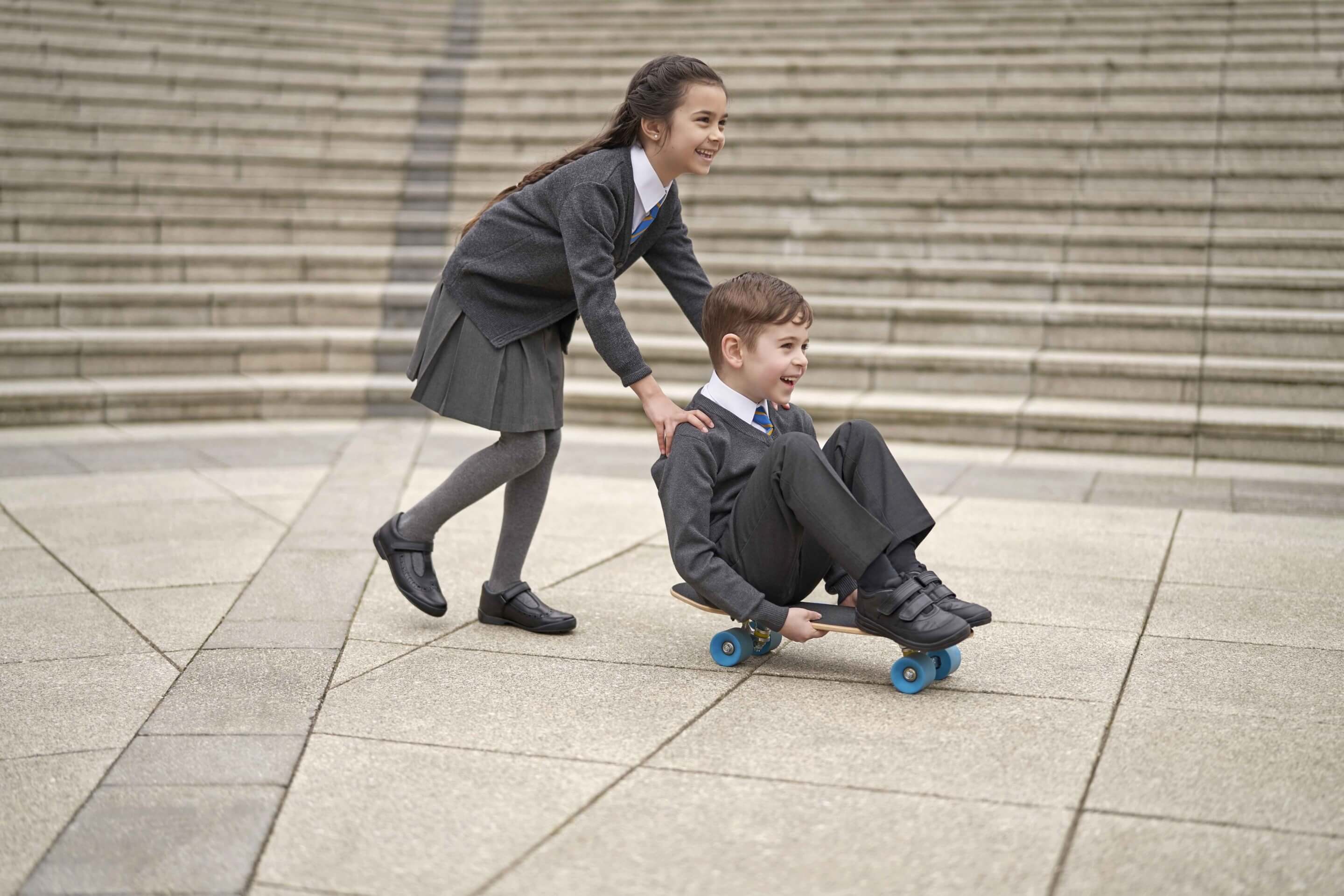 Girl and Boy Playing on Skateboard